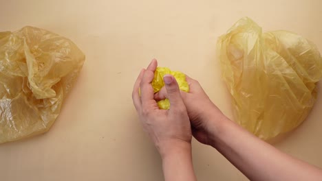 Hand-pick-plastic-bag-on-table