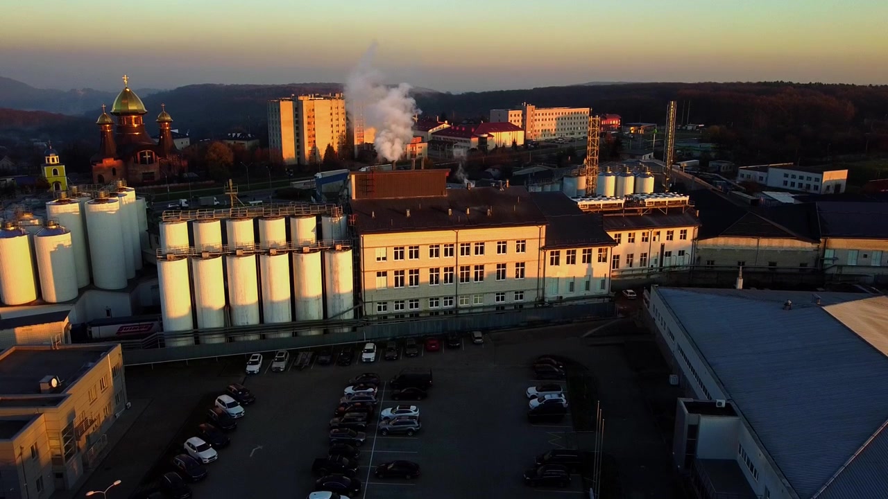 Aerial view of a drone flying over the beer production plant, several rows of tanks.