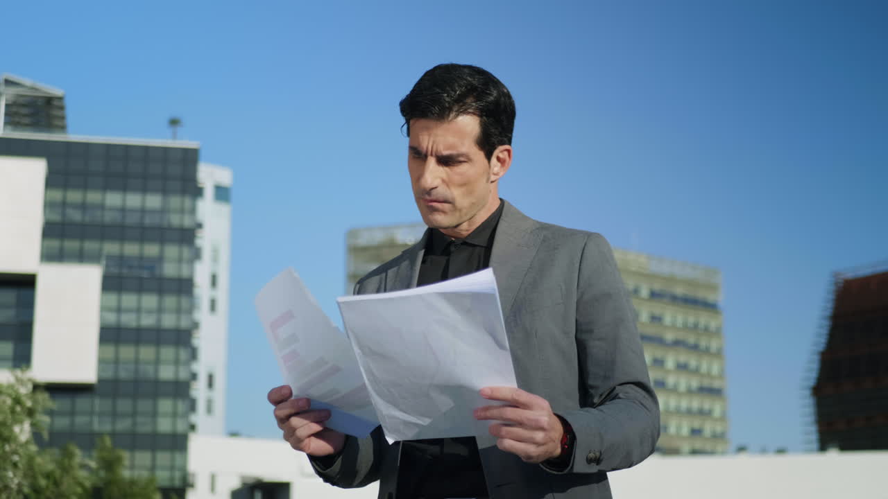 Businessman working with papers on street