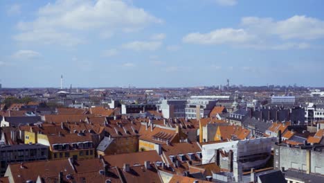 colourful rooftop view over copenhagen with light clouds in the sky