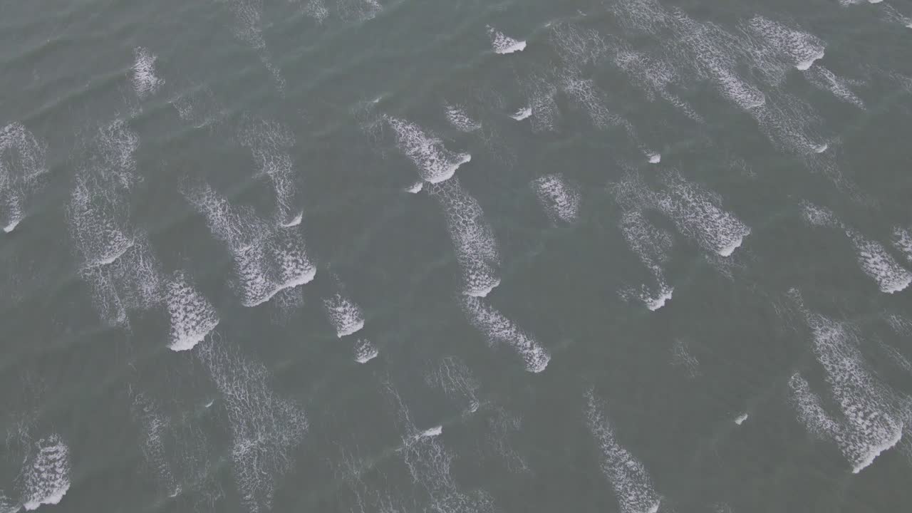 Aerial View Of Small Waves Rolling In The Sea