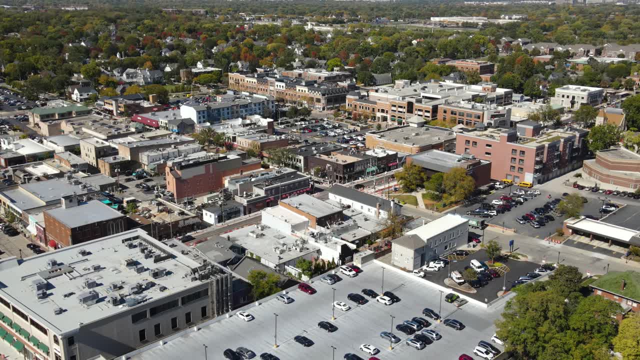 Naperville, IL, a Chicago suburb, on a sunny fall day, featuring buildings, streets. Crane Down Right Zoom Day NW