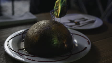 close-view-of-gourmet-dessert-made-of-chocolate,-set-on-fire-to-create-a-mesmerising-melting-effect