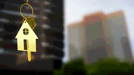 animation of gold house key fob and key, hanging in front of blurred city high rise buildings