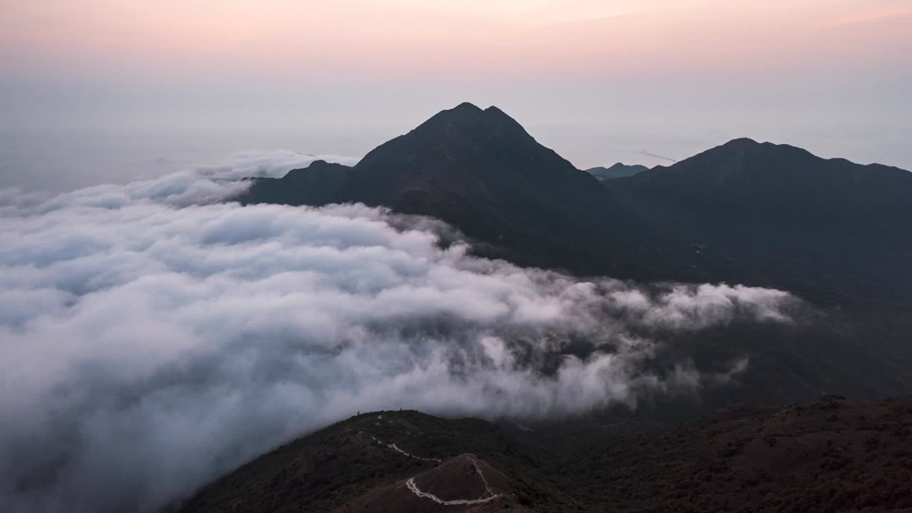 Sunset seen from Sunset Peak, Hong Kong with people walking the stony path in mountain. Hyperlapse. Footage B roll white clouds dense fog move quickly. Hyper lapse fluffy clouds moving. Fog Sea.