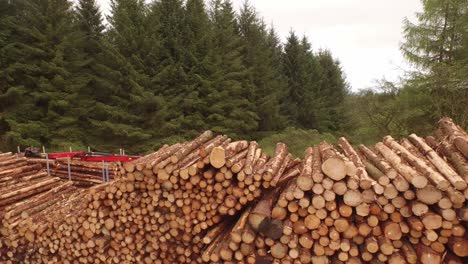 Forestry-and-logging-operations-taking-place-in-the-highlands-of-Scotland-using-large-industrial-machinery,-ships-and-trucks