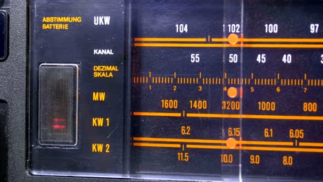 tuning analog radio dial frequency on scale of the vintage receiver