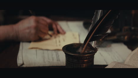 an old captain sits writes a letter inside the sailing ship cabin