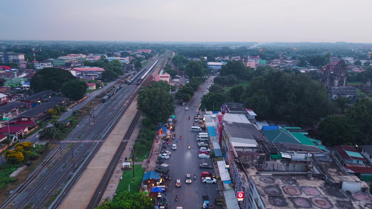 Aerial View of a Town with Train Tracks and Market