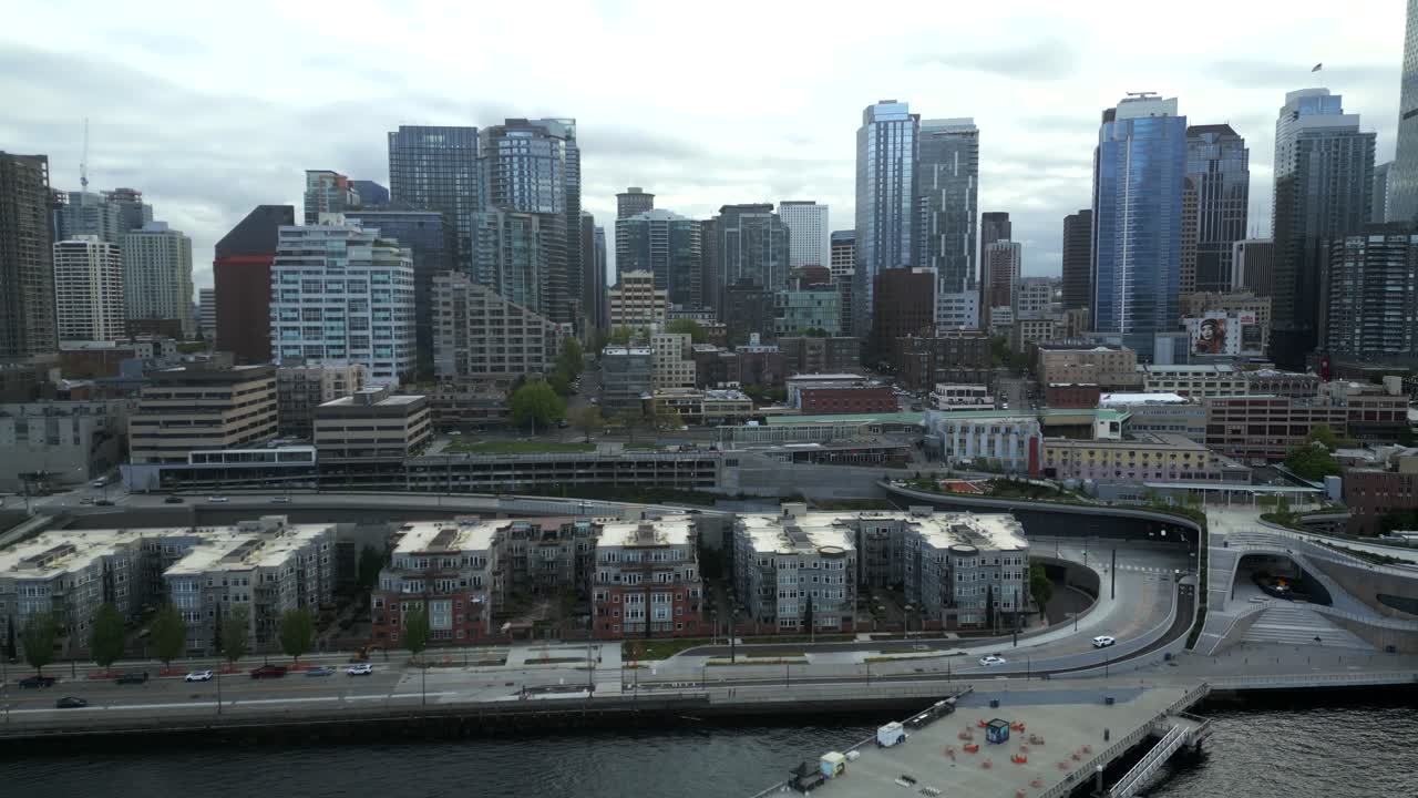 Scenic aerial view of coastal roads and apartment buildings at Seattle Waterfront with downtown area background - Seattle, Washington, USA