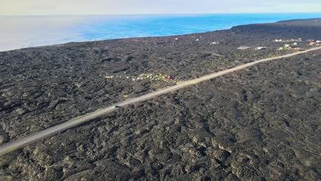 Stunning-drone-shot-capturing-the-expansive-old-lava-field-as-a-small-community-re-emerges,-taking-root-on-this-unique-and-transformative-landscape