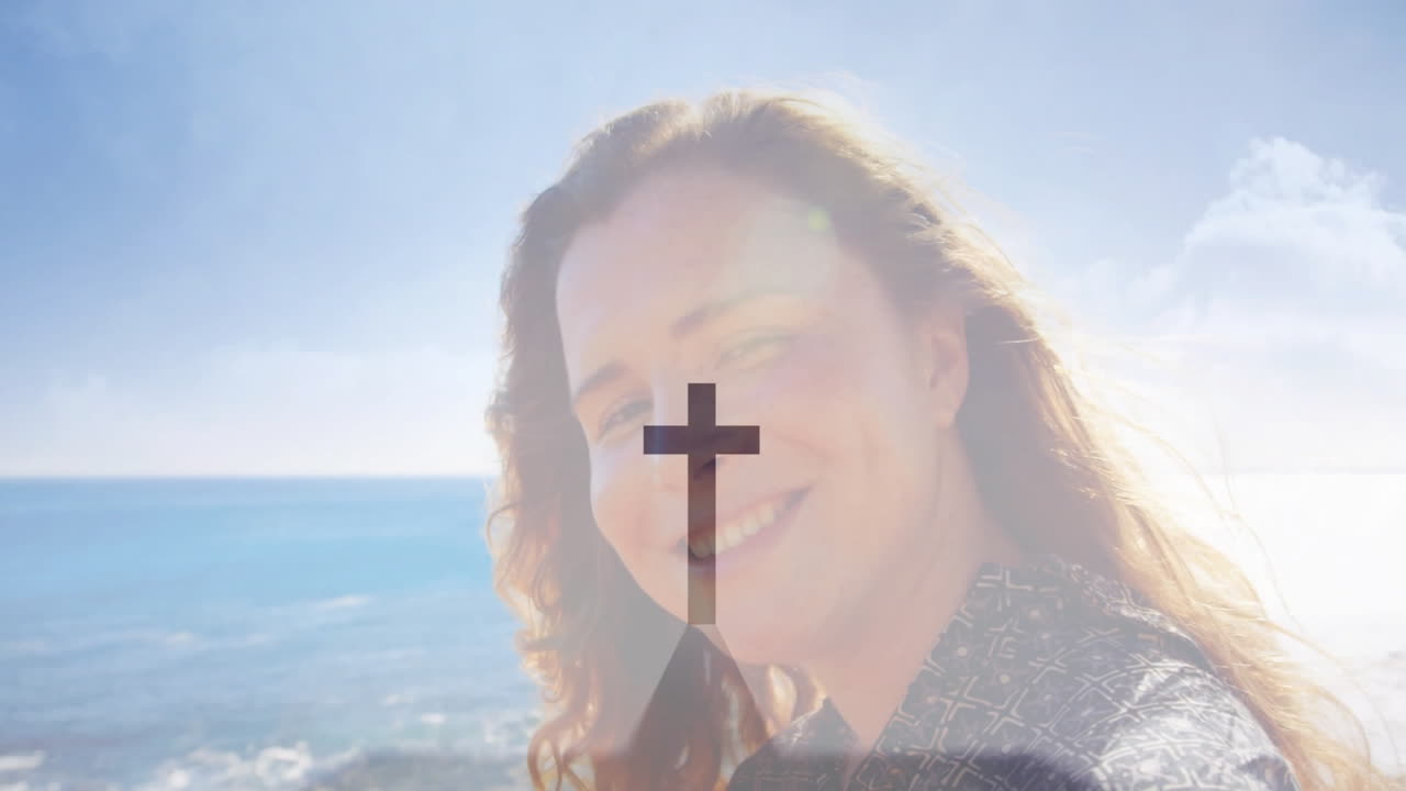 At beach, person with cross symbol overlay on face, creating animation