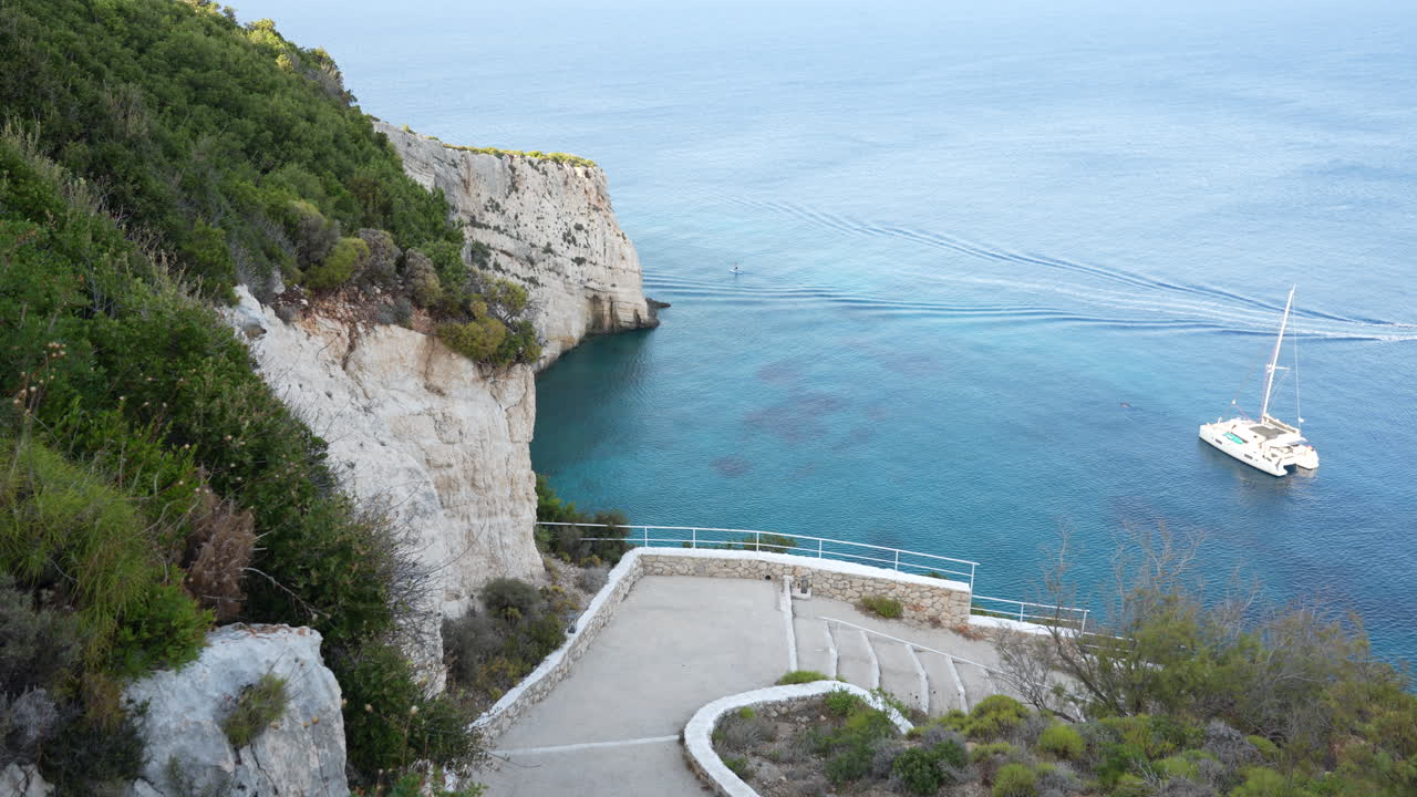 Cliffs above the turquoise ocean, a serene view with calm blue water and lush greenery