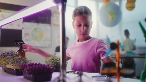 girl student conducting science experiment in classroom