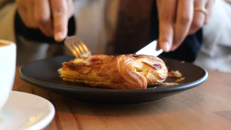 eating a pastry in a cafe