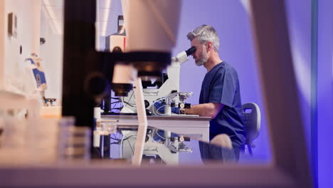 scientist working in a laboratory using microscope