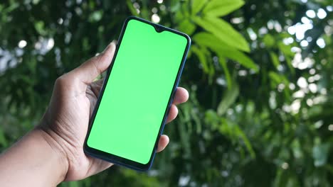 Rear-view-of-young-man-using-smart-phone-at-outdoor