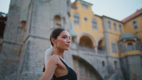 woman stretching in front of a castle