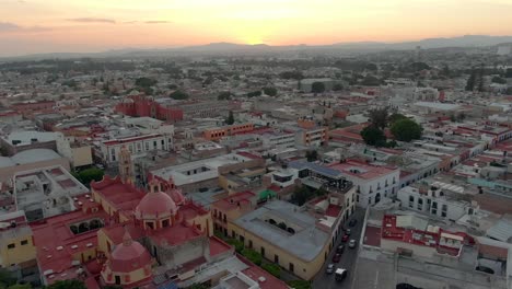Fly-Over-Our-Lady-Of-Guadalupe-To-San-Antonio-de-Padua-Templo-At-Sunset-In-Santiago-de-Querétaro,-Mexico