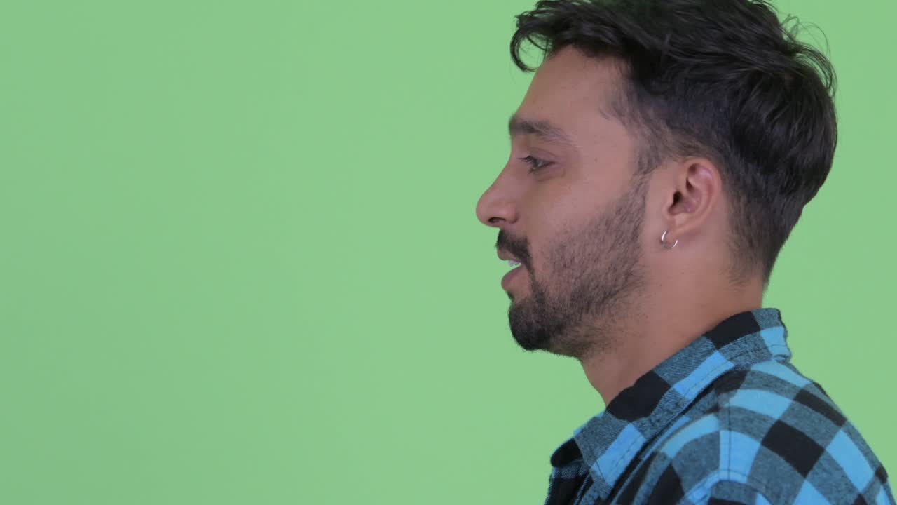 Young handsome bearded Persian hipster man