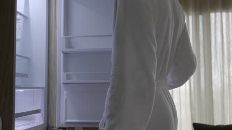 Man-In-Bathrobe-Get-A-Refreshing-Canned-Drink-On-Refrigerator