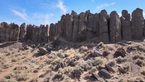 basalt columns makeup a natural wall along frenchman's coulee, aerial reveal