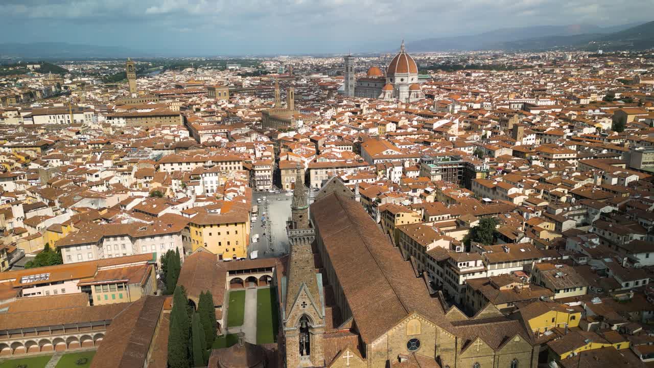 Drone che si avvicina dal retro della Basilica di Santa Croce a Firenze, Italia, mentre un'ombra di nuvola passa sopra