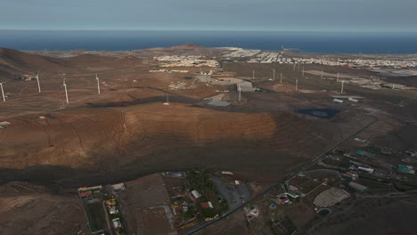 sunset aerial panorama revealing wind turbines near roque aguayro, capturing gran canaria's renewable energy landscape with dramatic natural lighting