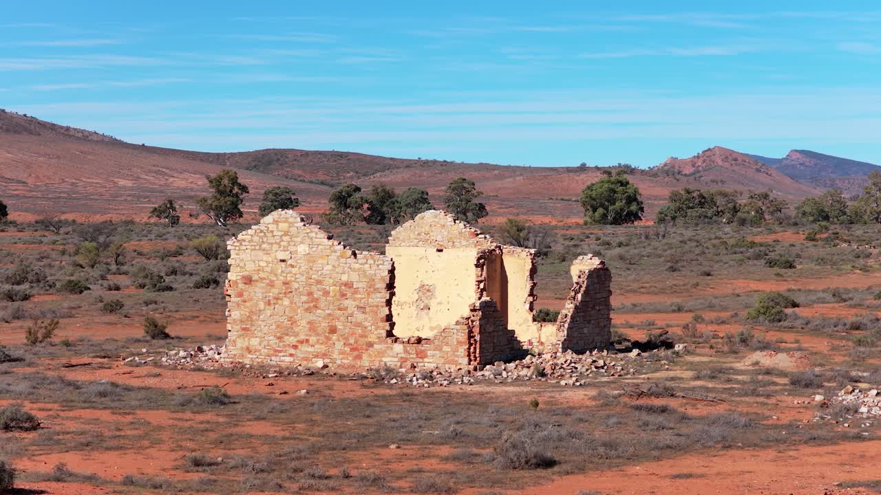 Aerial orbit shot circling historic stone ruin in Flinders Ranges outback, South Australia