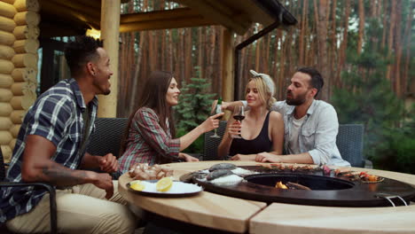 Cheerful-guys-gathering-on-grill-party-outside.-Guy-showing-thumbs-up-outdoors