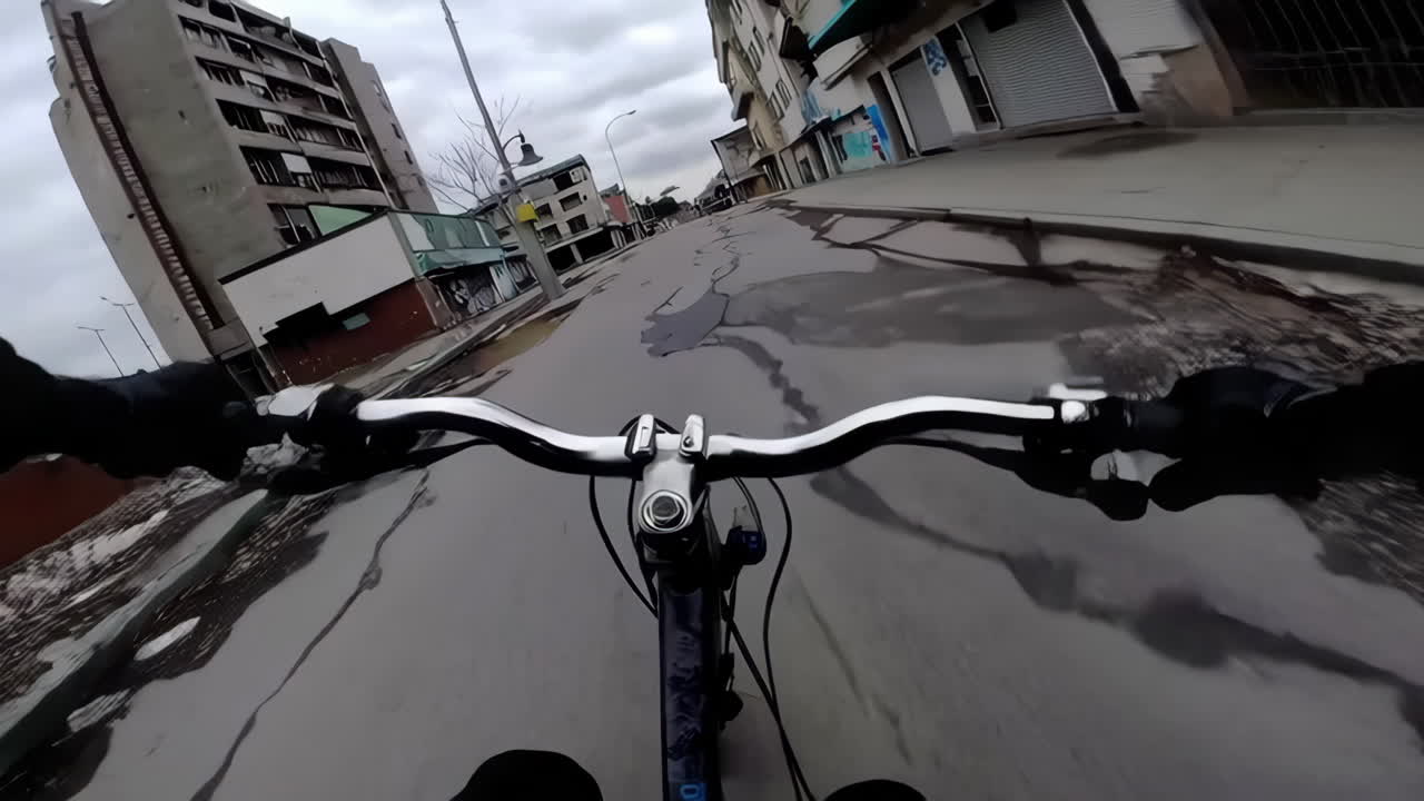 Cycling through a rainy, urban, abandoned area