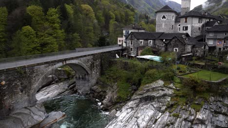 pan up to church in lavertezzo verzasca switzerland at base of alps in valley