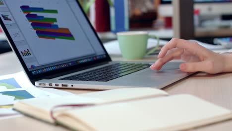 Close-up-of-business-woman-working-with-laptop-computer-in-office