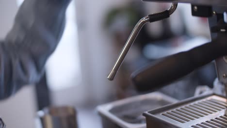 barista clearing steam wand