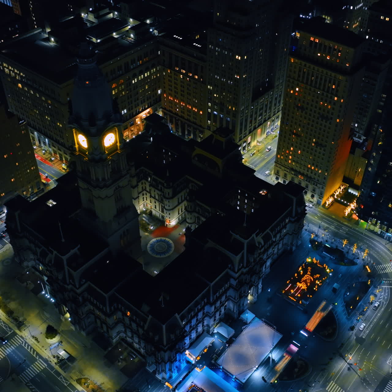 The clock is lit on the tower of gorgeous Philadelphia City Hall at night. Top view on the seat of the municipal government of in the U.S. state of Pennsylvania.