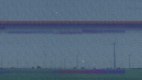 grainy static panorama showing flat grassy field punctuated by fence posts and turbine silhouette