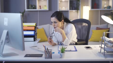 senior businesswoman working at night in her home office.