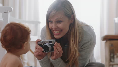 Madre-Feliz-Tomando-Una-Foto-Del-Bebé-Usando-Una-Cámara-Mamá-Emocionada-Fotografiando-A-Un-Niño-Lindo-Disfrutando-Del-Estilo-De-Vida-De-La-Maternidad-Creando-Recuerdos