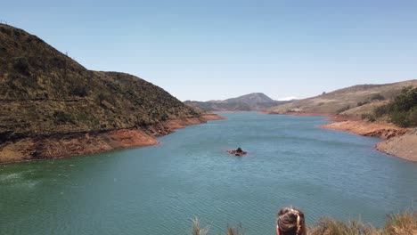 tourist looks out onto upper bhavani lake in nilgiri biosphere reserve outside ooty, tamil nadu, india