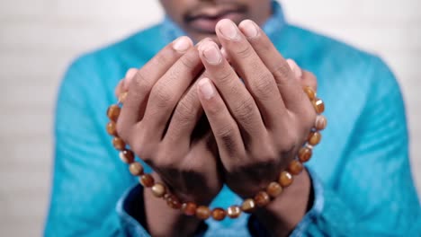 muslim man praying during ramadan, close up