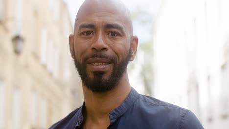 Portrait-Of-An-Afro-Caribeean-Man-Smiling-And-Looking-At-Camera-In-The-Old-Town-Street-3