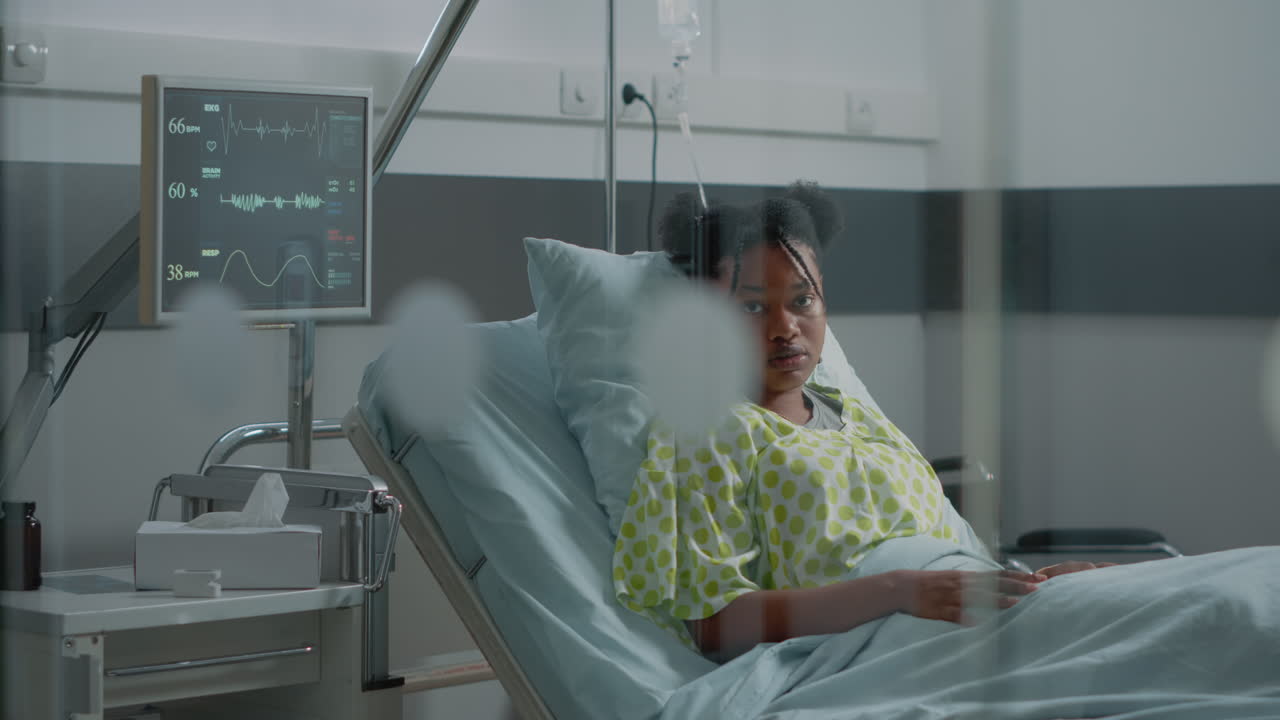Portrait of african american woman sitting in hospital ward