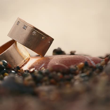 Wedding-rings-on-stones-against-the-background-of-the-sea