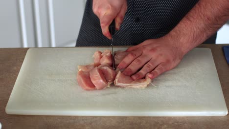 Cutting-chicken-on-cutting-board