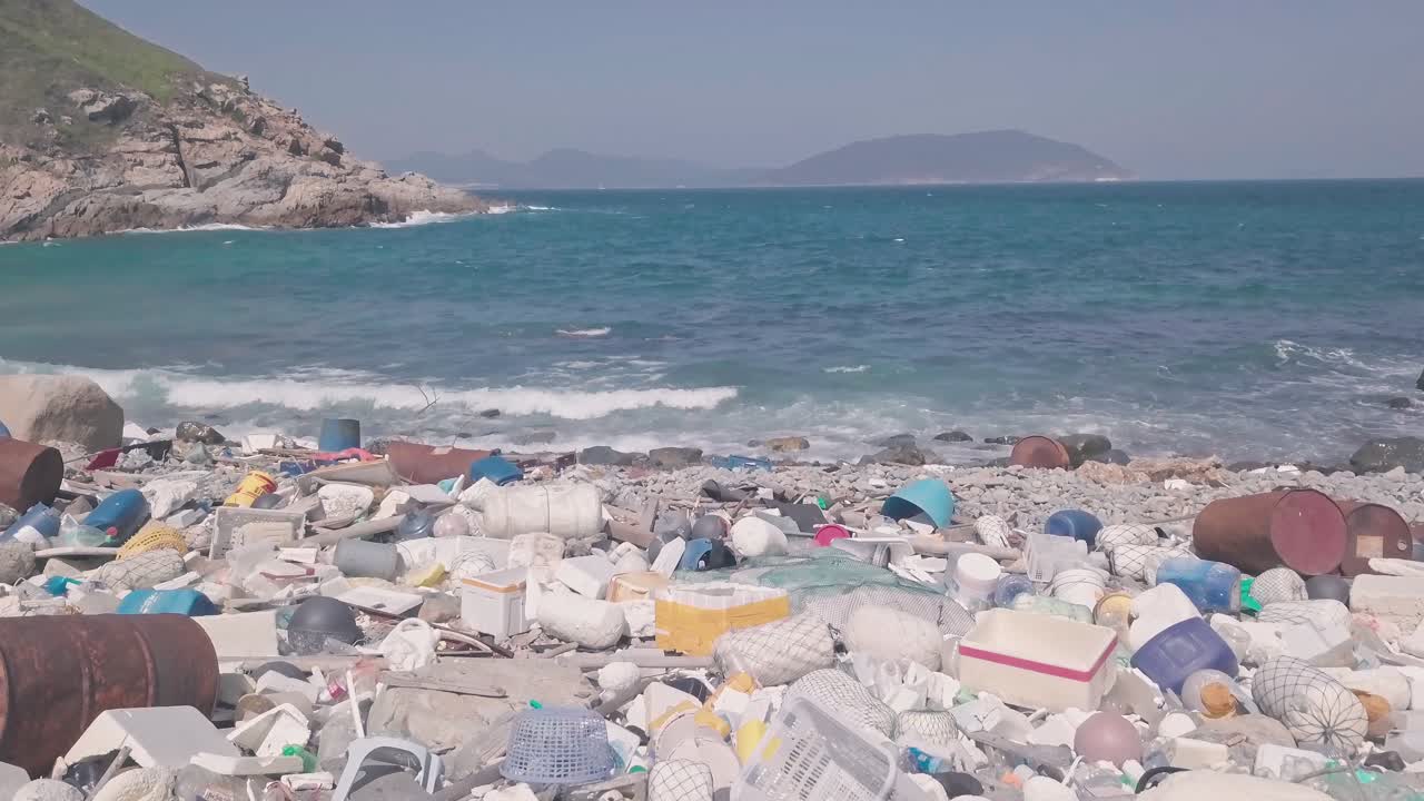 Environmental impact of Beach covered in plastic and rubbish in Hong Kong. Aerial drone view