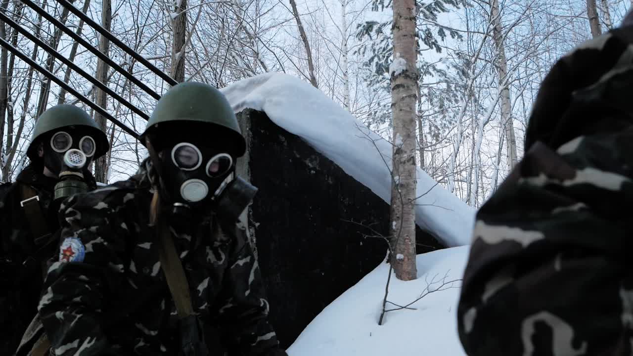 Soldiers in Protective Gear in Snowy Terrain