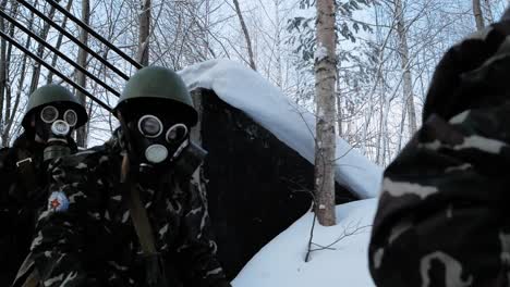 soldiers in protective gear in snowy terrain