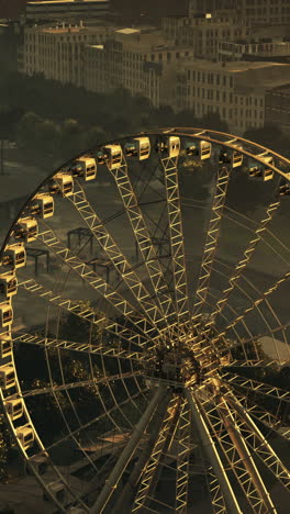 aerial view of ferris wheel in city at night