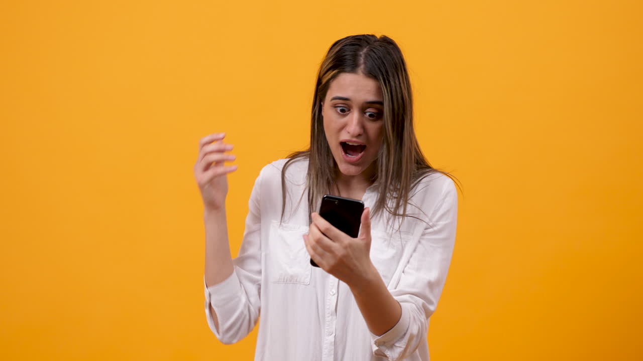 Woman Reacts to Exciting News on Phone