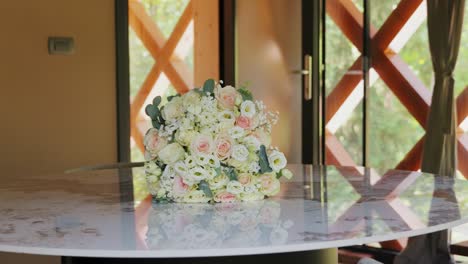 beautiful bride's bouquet of white roses prepared on a table